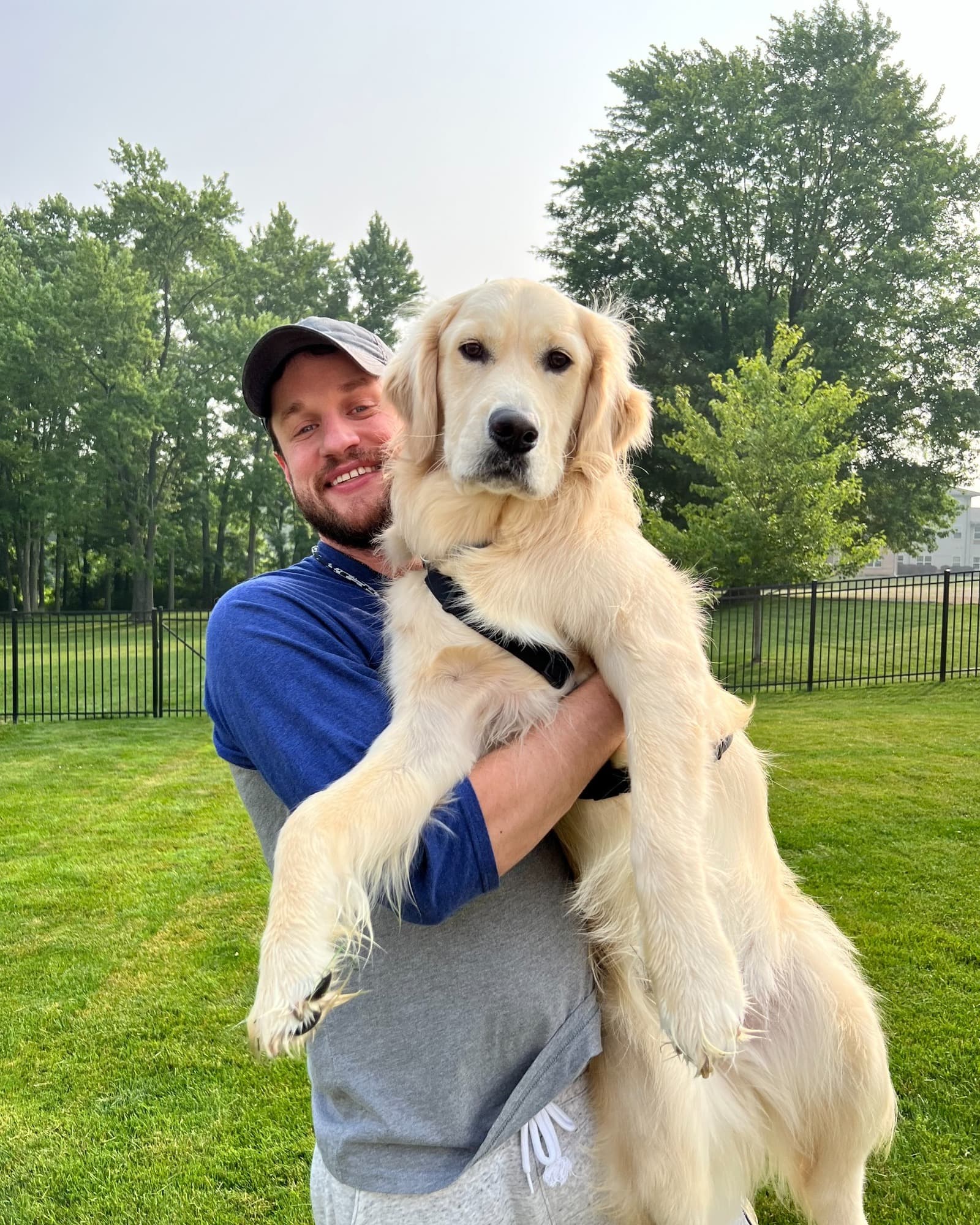 Eric holding his golden retriever