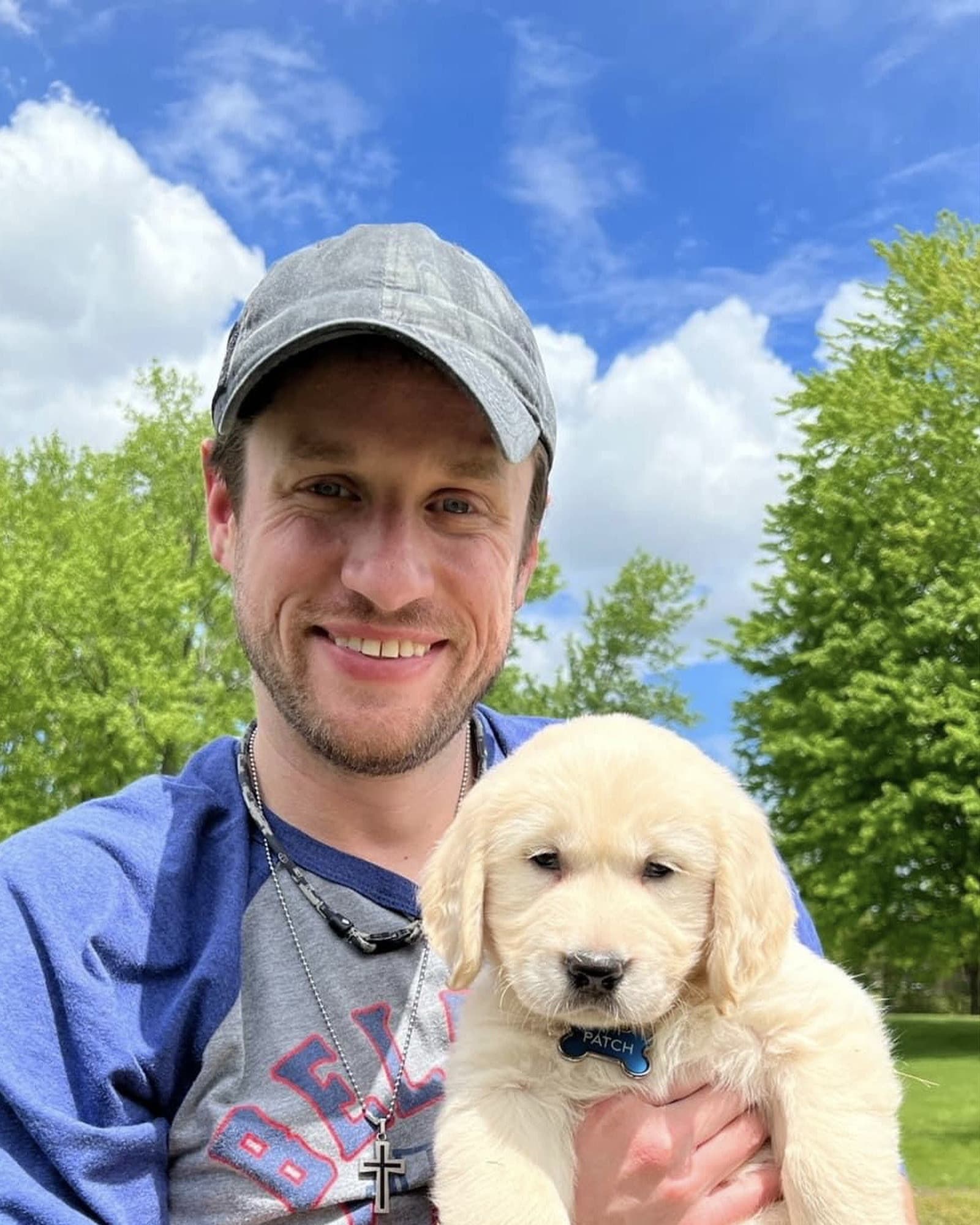 Eric with his golden retriever puppy
